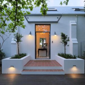 A white house with a pathway leading to the front door at Chapter House Boutique Hotel by The Living Journey Collection in Franschhoek
