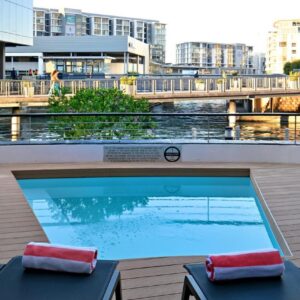 A swimming pool on top of a building with a bridge at City Lodge Hotel V&A Waterfront in Cape Town
