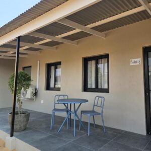 A patio with a blue table and two chairs at Clanwilliam Accommodation in Clanwilliam