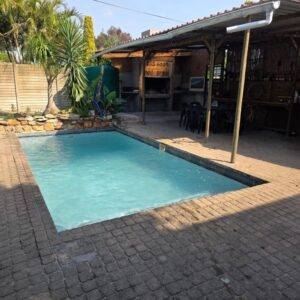 The swimming pool and braai area at CLR-Accommodation in George