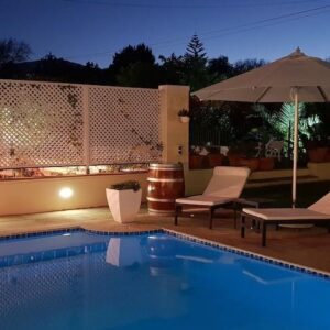 The swimming pool and terrace at dusk at Constantia Cottages in Constantia, Cape Town