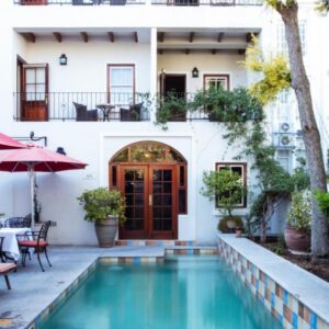 A house with a swimming pool in front of a building at Coopmanhuijs Boutique Hotel & Spa in Stellenbosch