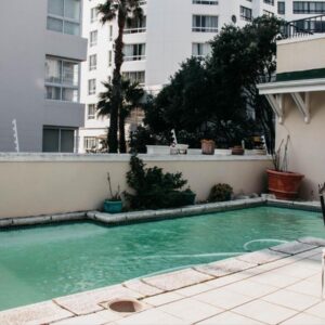 A swimming pool in front of a building at Craigrownie Luxury Guest House in Cape Town