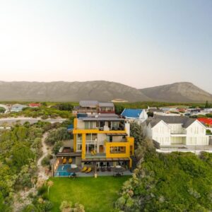 An aerial view of a yellow house at Crayfish Lodge Sea & Country Guest House in Gansbaai