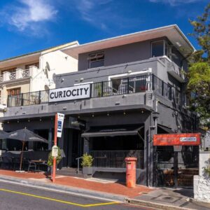 A building on the corner of a street at CURIOCITY Kloof Street in Cape Town