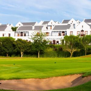 A golf course with a large white house in the background at De Zalze Lodge in Stellenbosch