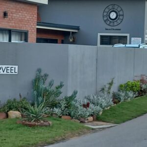 A retaining wall in front of a building at Diaz Guesthouse in Mossel Bay