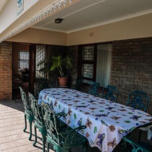 A table and chairs on a patio at Die C Skulp in Hartenbos
