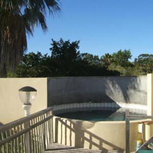 A small swimming pool with a fence and a staircase at Disa Lodge in Darling