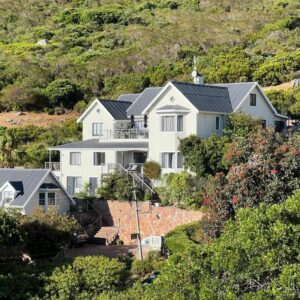 A large white house on the side of a hill at Dunvegan Lodge in Clovelly