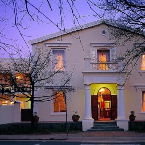 A white house with its lights on at Eendracht Hotel in Stellenbosch