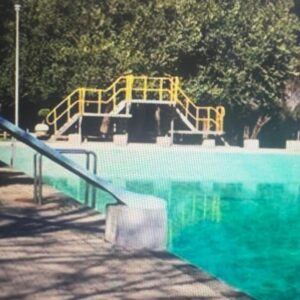 A playground with a slide next to a swimming pool at Family Resort Escape De Hollandsche Molen in Hou Moed