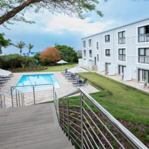 A view of the courtyard of a building with a swimming pool at Garden Route Hotel in Mossel Bay