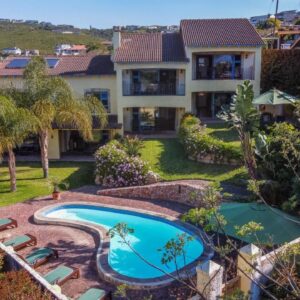 An aerial view of a house with a swimming pool at Gästehaus Pinkepank in Plettenberg Bay