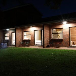 A brick house at night with lights at Gemstone Farm in Plettenberg Bay