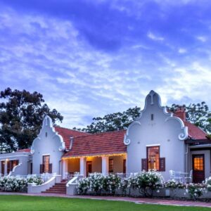A white house with a red roof at Glen Avon Lodge - Constantia in Cape Town