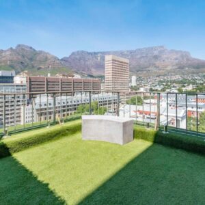 A balcony with grass and a view of a city at Habitat Aparthotel by Totalstay in Cape Town