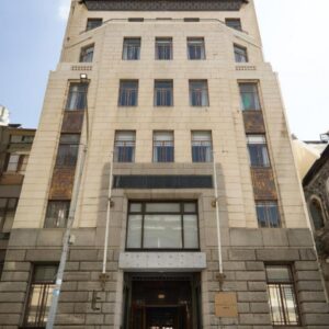 A tall stone building with a door at Hotel Bruxelles in Cape Town