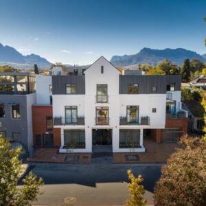 An aerial view of a house with mountains in the background at Hotel Krige in Stellenbosch