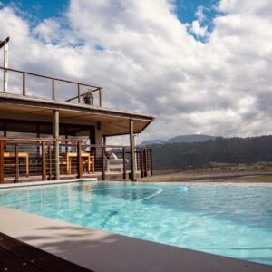 A large swimming pool in front of a building at Interlaken Guest House in Wilderness