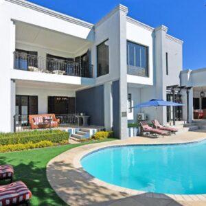 A house with a swimming pool in front of it at Kilima Franschhoek in Franschhoek