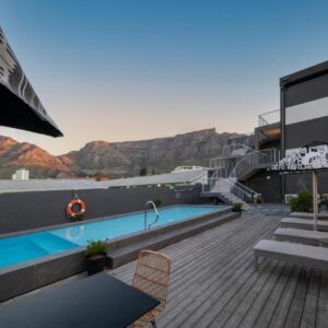 A rooftop pool and sun deck with Table Mountain in the background at Kloof Street Hotel in Cape Town