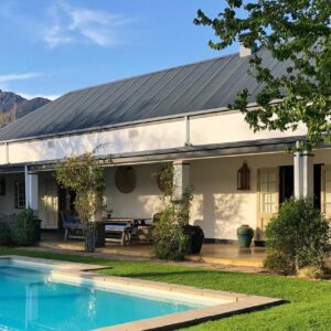 A house with a swimming pool in front of it at La Clé Village in Franschhoek