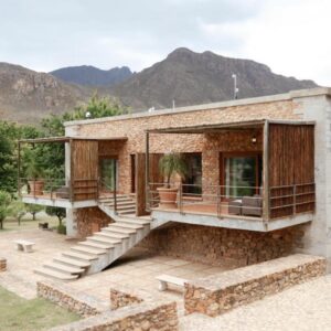 A house with mountains in the background at La Roche Estate in Franschhoek