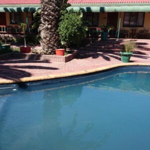 A large swimming pool in front of a house at Lamberts Bay Hotel in Lambertʼs Bay