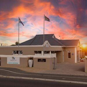 A building with three flags on top of it at Langebaan Stay Guest House in Langebaan