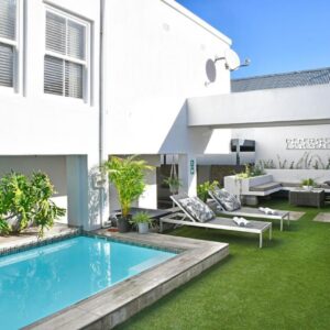 A swimming pool in the backyard of a house at Le Petit Bijou Aparthotel in Franschhoek
