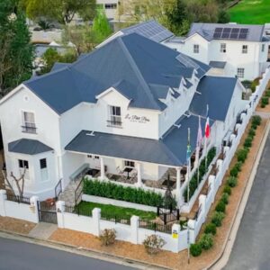 An aerial view of a white house with a blue roof at Le Petit Paris in Franschhoek