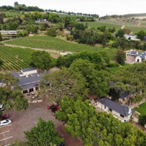 An aerial view of a house with a yard and trees at Le Pommier Wine Estate in Stellenbosch
