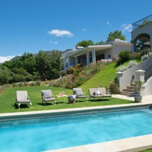 A backyard with a swimming pool and a house at Le Vine Constantia in Cape Town