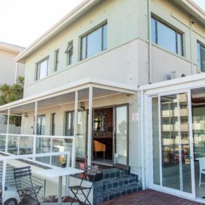A house with sliding glass doors and a patio at Leeuwenzee Guesthouse in Cape Town