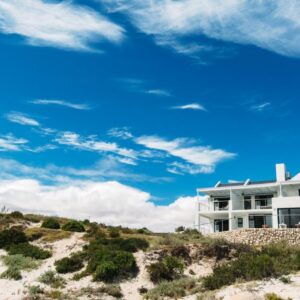 A white building on top of a sandy beach at Linhof Boutique Guest House in Paternoster