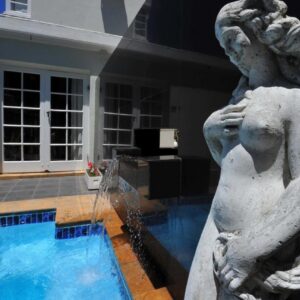 A statue in front of a swimming pool at Little Scotia in Cape Town