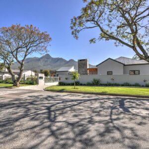 A house on a street with a tree shadow at Lorelei Guest House in George