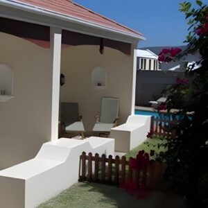The white lodge with a plunge pool and bougainvillea at Milkwood Lodge in Hermanus