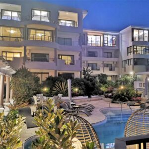 A large apartment building with a swimming pool at Misty Waves Boutique Hotel in Hermanus
