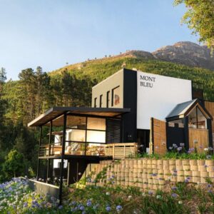 A house on the side of a hill with flowers at Mont Bleu Guesthouse in Franschhoek