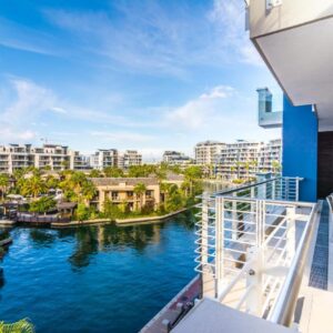 A balcony with a view of a river with buildings at Mountain Marina Luxury Apartments in Cape Town