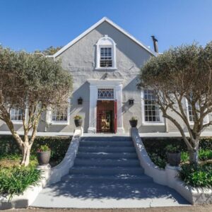 A white house with stairs leading to the front door at Nantes-Vue in Paarl