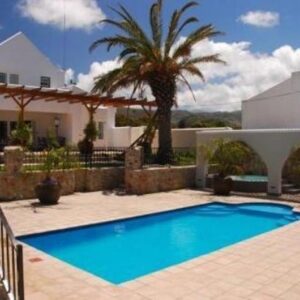 A swimming pool in front of a house at Nautilus Guest House in Hermanus