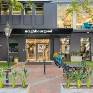 A building with tables and benches in front of it at Neighbourgood East City in Cape Town