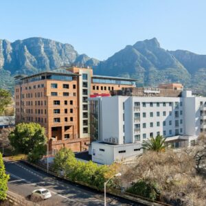 A view of a city with mountains in the background at Neighbourgood Newlands in Cape Town