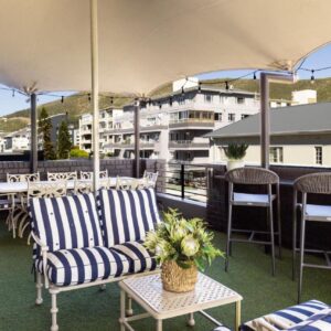 A patio with chairs and tables and an umbrella at Newkings Boutique Hotel in Cape Town
