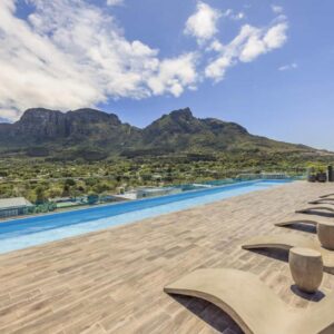 A row of benches on the roof of a building with mountains at Newlands Peak Apartments in Cape Town