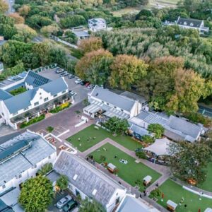 An aerial view of a building with a park at Noordhoek Village Hotel in Noordhoek