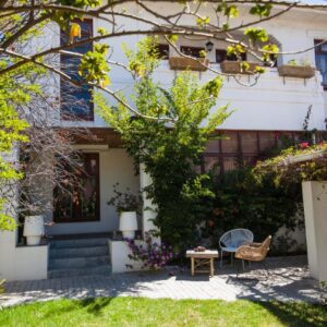 A white house with a garden in front of it at Number5 Guesthouse in Cape Town